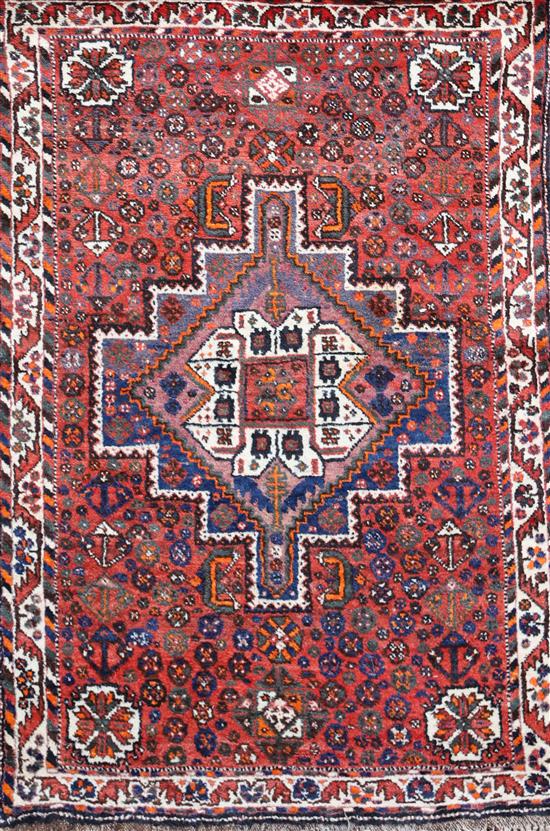 A Shiraz design red ground rug, 5ft 3in by 3ft 8in.